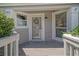 Quaint front porch featuring a storm door, bay windows, and view of well-maintained landscaping at 433 Double Eagle Trace, Seabrook Island, SC 29455