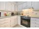 Well-lit kitchen with white cabinets, modern appliances, and ample counter space at 433 Double Eagle Trace, Seabrook Island, SC 29455