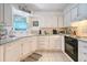 Bright kitchen featuring white cabinets, modern appliances, and lots of counter space at 433 Double Eagle Trace, Seabrook Island, SC 29455