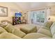 Inviting living room with comfortable seating, a TV, and an open view of the screened porch at 433 Double Eagle Trace, Seabrook Island, SC 29455
