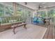 Comfortable screened porch with ceiling fans, ample seating, and views of the lush greenery outside at 433 Double Eagle Trace, Seabrook Island, SC 29455