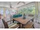 Inviting screened porch with wooden floors, outdoor dining, and serene views at 433 Double Eagle Trace, Seabrook Island, SC 29455