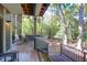 Inviting back porch with wooden rocking chairs overlooking lush green trees and landscaped yard at 4901 Green Dolphin Way, Kiawah Island, SC 29455
