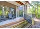 Spacious back porch with gray chairs overlooking lush greenery, offering a tranquil outdoor living space at 4901 Green Dolphin Way, Kiawah Island, SC 29455