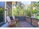Cozy back porch with wood rocking chairs, offering a relaxing and picturesque view of lush greenery and trees at 4901 Green Dolphin Way, Kiawah Island, SC 29455