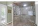 Walk-in shower featuring marble tile, glass enclosure and seat at 4901 Green Dolphin Way, Kiawah Island, SC 29455