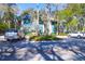 Attractive condo with teal siding, sidewalks, palm trees, and convenient parking at 4901 Green Dolphin Way, Kiawah Island, SC 29455