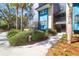 Stylish condo with lush landscaping, teal siding, and easy access to unit via path and stairs at 4901 Green Dolphin Way, Kiawah Island, SC 29455