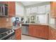 Functional kitchen featuring stainless steel appliances, wood cabinetry, and seamless access to the living spaces at 4901 Green Dolphin Way, Kiawah Island, SC 29455