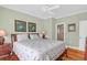 Main bedroom featuring ceiling fan, hardwood floors, art and a bathroom entrance at 4901 Green Dolphin Way, Kiawah Island, SC 29455