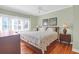 Bright main bedroom with hardwood flooring, ceiling fan and two side tables at 4901 Green Dolphin Way, Kiawah Island, SC 29455
