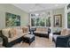Bright sunroom with large windows, neutral color palette, ceiling fan, and comfortable seating at 4901 Green Dolphin Way, Kiawah Island, SC 29455