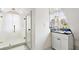 Cozy bathroom featuring a walk-in shower with glass door, granite countertop, and a sunny window at 5 Alexander St, Charleston, SC 29401