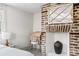 Charming bedroom with vintage brick fireplace, wooden desk, and natural light at 5 Alexander St, Charleston, SC 29401