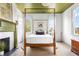 Bright bedroom with a four-poster bed, fireplace, and lots of natural light at 5 Alexander St, Charleston, SC 29401