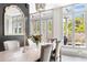 Elegant dining room featuring a rustic wood table, garden views and plenty of natural light at 5 Alexander St, Charleston, SC 29401