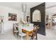 Bright dining room featuring a rustic table, elegant chairs, pendant lighting and open plan to kitchen at 5 Alexander St, Charleston, SC 29401