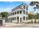 Charming exterior of a two-story home with a grand columned balcony and landscaped yard at 5 Alexander St, Charleston, SC 29401