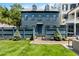 Charming two-story home with a beautiful front yard and inviting entryway with blue fence and brick walkway at 5 Alexander St, Charleston, SC 29401