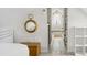 Bright hallway with white plank flooring leading to a shower with a glass door and brass fixtures at 5 Alexander St, Charleston, SC 29401