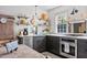 Well-equipped kitchen with custom cabinets, stainless steel appliances and open shelving with decorative items at 5 Alexander St, Charleston, SC 29401