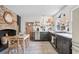 Eat-in kitchen with an antique fireplace, modern appliances, and open shelving with decorative items at 5 Alexander St, Charleston, SC 29401