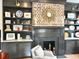 Living room with dark wood fireplace, unique mirror, and built-in bookshelves at 5 Alexander St, Charleston, SC 29401
