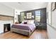 Spacious main bedroom featuring hardwood floors, a fireplace, and lots of natural light at 5 Alexander St, Charleston, SC 29401