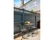 Outdoor patio area with stone flooring and metal table and chairs with moody blue wooden fence at 5 Alexander St, Charleston, SC 29401