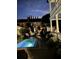 Inviting backyard pool with patio seating, professional landscaping, and brickwork at 5 Alexander St, Charleston, SC 29401