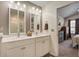 Bathroom with double vanity sinks, white cabinetry, and a decorative mirror at 509 Nadir Ct, Summerville, SC 29486