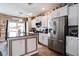 Bright kitchen with stainless steel refrigerator, white cabinetry, and a breakfast bar area at 509 Nadir Ct, Summerville, SC 29486