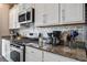 Modern kitchen with granite countertops, stainless steel appliances, and white cabinets at 509 Nadir Ct, Summerville, SC 29486