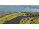 Scenic aerial view of a waterway and dock, surrounded by mature trees and open spaces at 6021 Jibe Ct, Awendaw, SC 29429