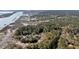 Scenic aerial view of waterfront properties nestled among lush trees with private docks and a serene river inlet at 6021 Jibe Ct, Awendaw, SC 29429