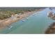 Stunning aerial view of waterfront homes with private docks along a serene river inlet and scenic marshland views at 6021 Jibe Ct, Awendaw, SC 29429