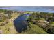 Aerial view of a serene pond surrounded by lush greenery, showcasing natural beauty and water features at 6021 Jibe Ct, Awendaw, SC 29429