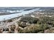 Picturesque aerial view featuring waterfront homes with private docks along a tranquil river and natural landscape at 6021 Jibe Ct, Awendaw, SC 29429