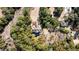 Stunning aerial view of a home nestled among lush trees, offering privacy and a tranquil setting at 6021 Jibe Ct, Awendaw, SC 29429