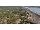 Scenic aerial view of a wooded property along the coast, showcasing lush greenery and waterfront access at 6021 Jibe Ct, Awendaw, SC 29429