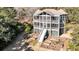 Backyard aerial showing an elevated home with an outdoor screened area and tiered garden at 6021 Jibe Ct, Awendaw, SC 29429