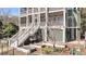 Home's exterior view highlights a raised garden, screened-in porch, and ground-level entry at 6021 Jibe Ct, Awendaw, SC 29429