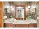 Bathroom featuring stylish vanity with decor, a large mirror and wall sconces at 6021 Jibe Ct, Awendaw, SC 29429