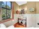 Charming powder room with a vessel sink, decorative elements, and a view of the outdoors through a large window at 6021 Jibe Ct, Awendaw, SC 29429