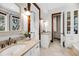 Bright bathroom with double vanities, ample storage, and neutral tiling at 6021 Jibe Ct, Awendaw, SC 29429