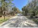 Gated entrance to the Romain Retreat community, featuring mature trees and a private setting at 6021 Jibe Ct, Awendaw, SC 29429