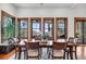 Elegant dining room with wood table, chairs, and large windows showcasing scenic outdoor views at 6021 Jibe Ct, Awendaw, SC 29429