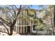 Stately elevated coastal home featuring a two-car garage and lush, mature trees at 6021 Jibe Ct, Awendaw, SC 29429