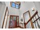 Bright foyer featuring wood trim, a staircase, and a view of the front door with sidelights at 6021 Jibe Ct, Awendaw, SC 29429