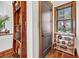 Hallway display shelf showcases unique decorative items and a window with natural light and wooden trim at 6021 Jibe Ct, Awendaw, SC 29429